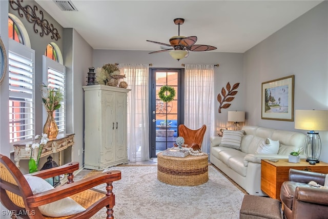 living room with visible vents and ceiling fan