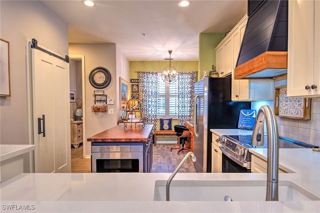 kitchen with premium range hood, an inviting chandelier, pendant lighting, white cabinetry, and backsplash