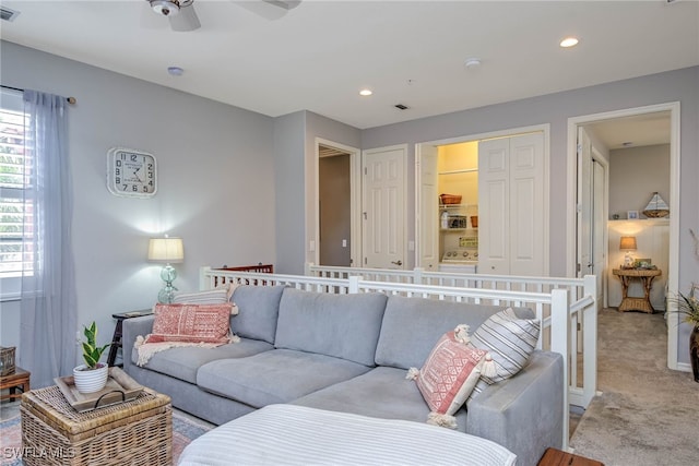 living area with recessed lighting, visible vents, light carpet, and ceiling fan