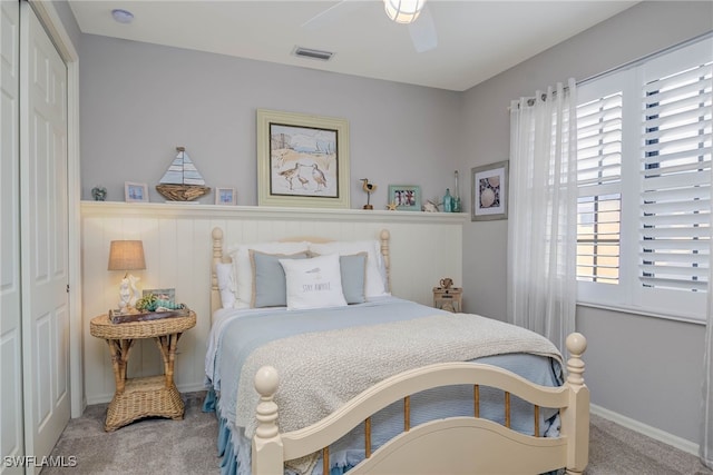 bedroom with visible vents, carpet, a closet, and ceiling fan