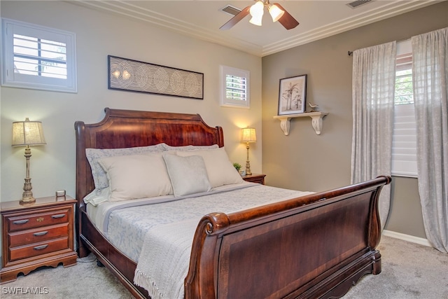 bedroom with visible vents, light carpet, a ceiling fan, and crown molding