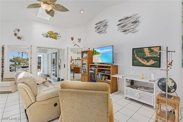 2810 Teal Ct, Saint James City, FL 33956 - living area with light tile patterned flooring, high vaulted ceiling, a skylight, and ceiling fan