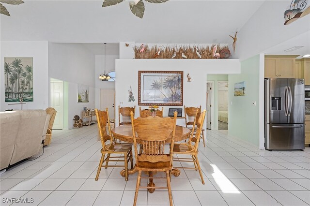 2810 Teal Ct, Saint James City, FL 33956 - dining room with light tile patterned flooring, ceiling fan with notable chandelier, and high vaulted ceiling