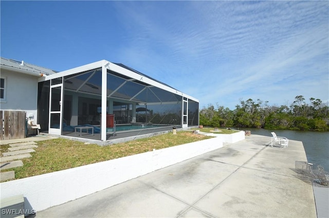 2810 Teal Ct, Saint James City, FL 33956 - view of patio featuring glass enclosure, a water view, and an outdoor pool