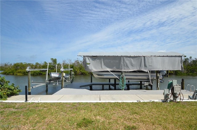 2810 Teal Ct, Saint James City, FL 33956 - view of dock with a water view, a lawn, and boat lift