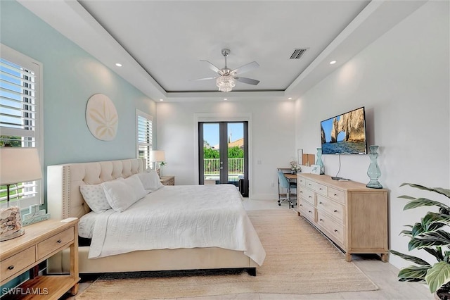 bedroom with a tray ceiling, visible vents, access to exterior, and recessed lighting