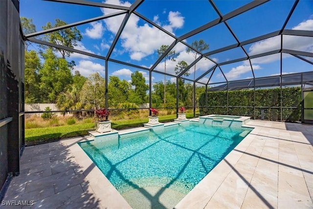 view of pool featuring a patio area, a lanai, and a pool with connected hot tub