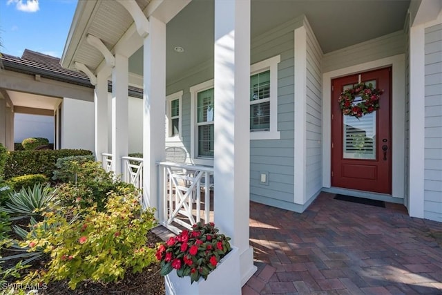 doorway to property featuring covered porch