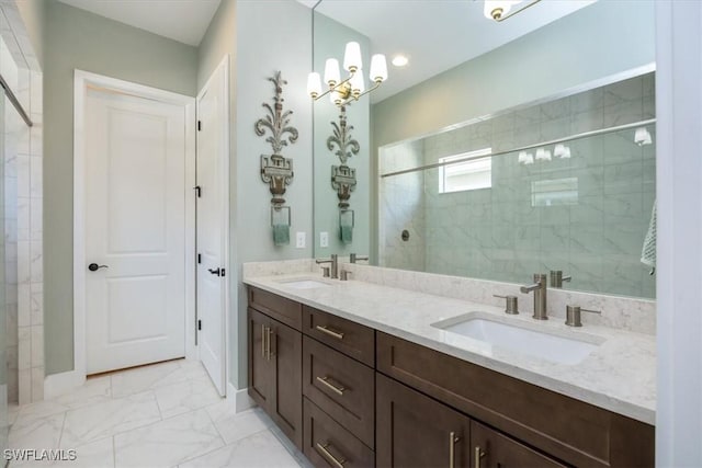 full bathroom with double vanity, marble finish floor, a shower stall, and a sink