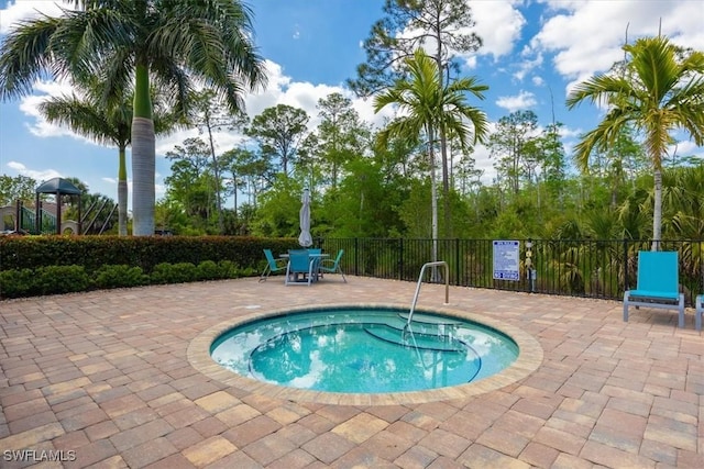 view of swimming pool with a patio and fence