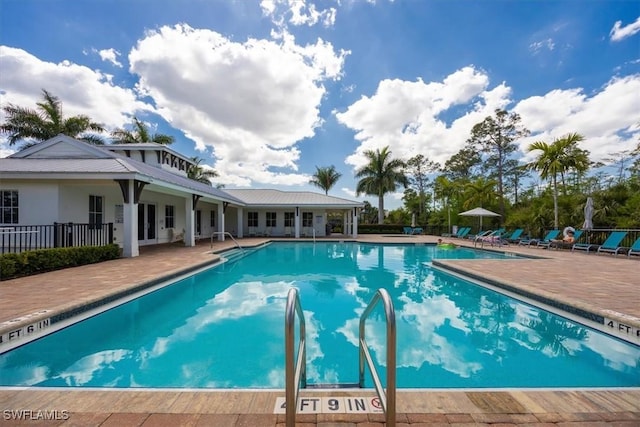 community pool with french doors and a patio