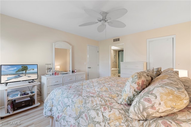 755 Village Cir Unit 203, Venice, FL 34292 - bedroom with visible vents, ensuite bath, light wood-type flooring, and a ceiling fan