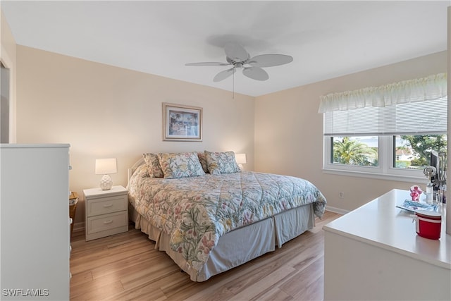 755 Village Cir Unit 203, Venice, FL 34292 - bedroom with light wood-style flooring, baseboards, and ceiling fan