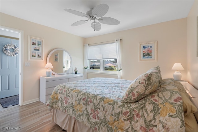 755 Village Cir Unit 203, Venice, FL 34292 - bedroom featuring baseboards, light wood-style floors, and a ceiling fan