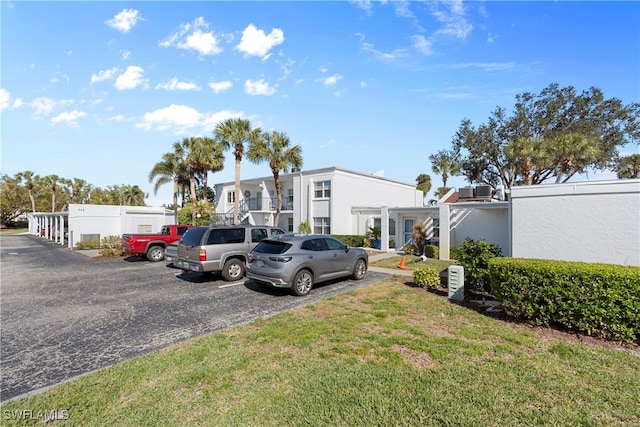 755 Village Cir Unit 203, Venice, FL 34292 - uncovered parking lot featuring a residential view