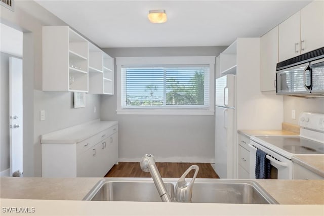 309 Goodlette-Frank Rd S Unit A305, Naples, FL 34102 - kitchen featuring white appliances, open shelves, and dark wood-type flooring