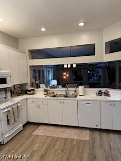 12713 Devonshire Lakes Dr, Fort Myers, FL 33913 - kitchen with white cabinets, a sink, electric range oven, light wood-style floors, and white microwave