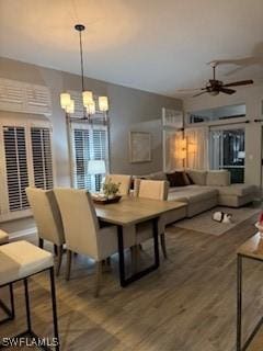 12713 Devonshire Lakes Dr, Fort Myers, FL 33913 - dining room with ceiling fan with notable chandelier and wood finished floors