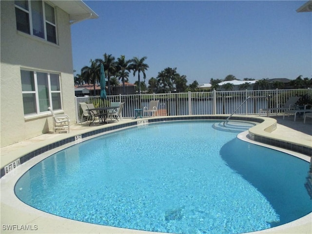 pool featuring a patio and fence