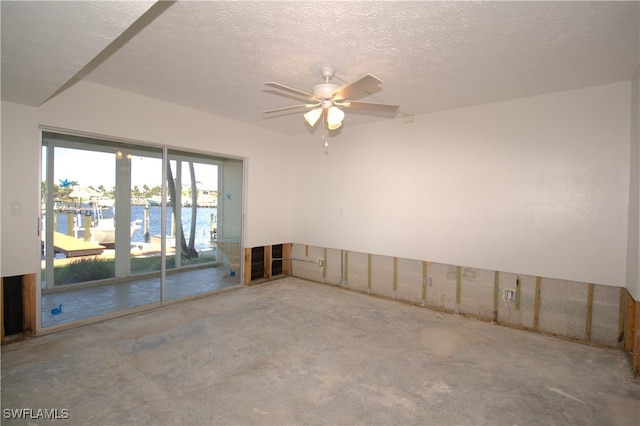 spare room with ceiling fan, concrete flooring, and a textured ceiling