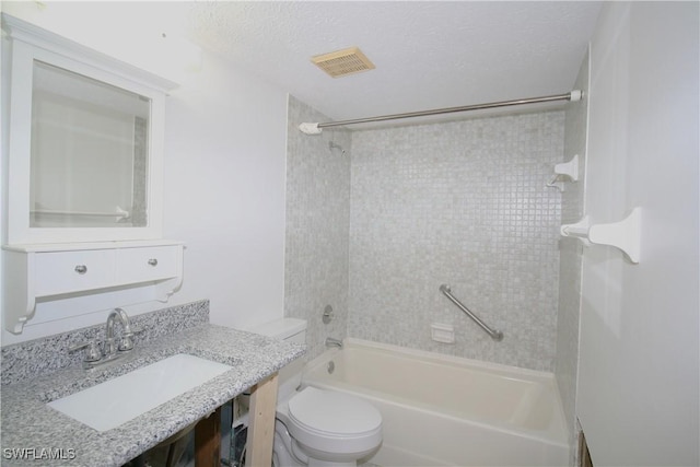 bathroom with visible vents, toilet, vanity, bathing tub / shower combination, and a textured ceiling