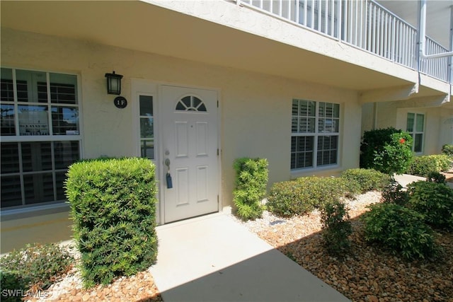 doorway to property with stucco siding