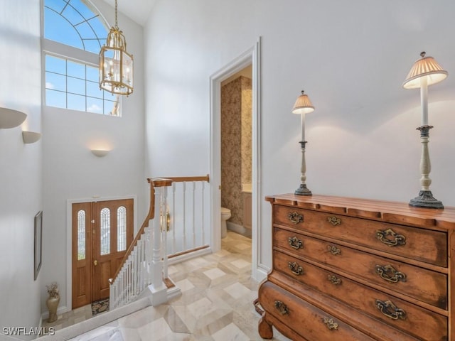 265 Colonade Cir, Naples, FL 34103 - entryway featuring stairs, a chandelier, and high vaulted ceiling