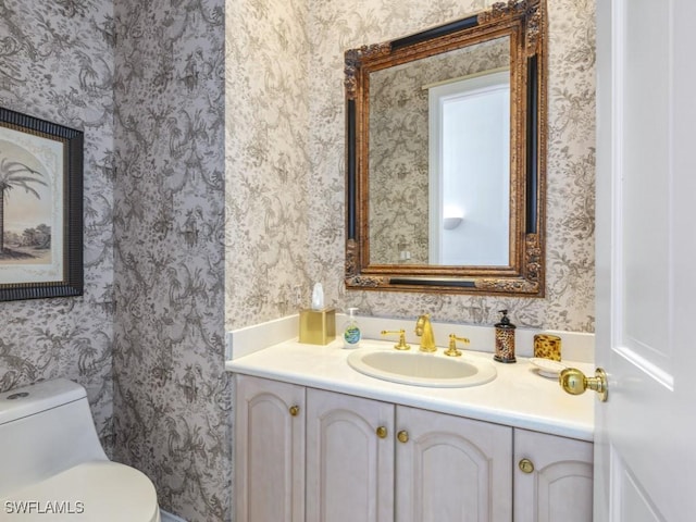 265 Colonade Cir, Naples, FL 34103 - bathroom featuring wallpapered walls, toilet, and vanity