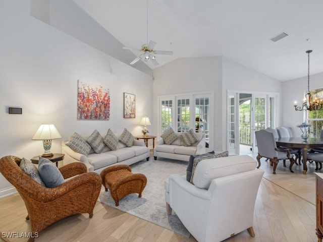 265 Colonade Cir, Naples, FL 34103 - living room featuring visible vents, ceiling fan with notable chandelier, high vaulted ceiling, and light wood-type flooring