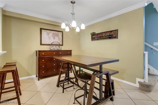 dining room featuring an inviting chandelier, crown molding, light tile patterned flooring, and baseboards