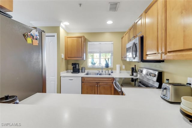 kitchen featuring visible vents, appliances with stainless steel finishes, light countertops, and a sink