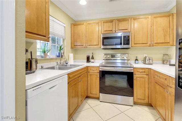 kitchen featuring a sink, light countertops, light tile patterned flooring, and stainless steel appliances