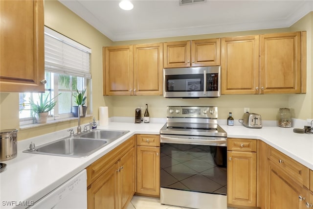 kitchen with a sink, appliances with stainless steel finishes, ornamental molding, and light countertops