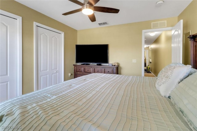 bedroom with a closet, visible vents, and a ceiling fan