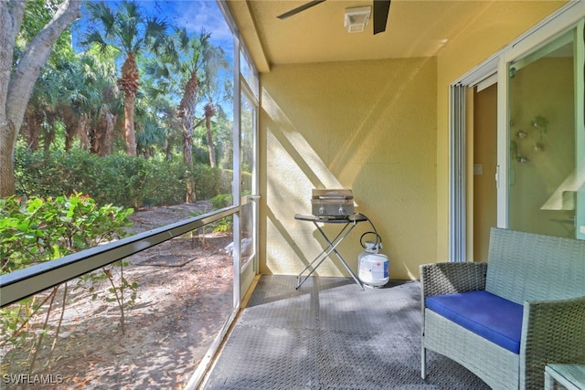 sunroom featuring ceiling fan