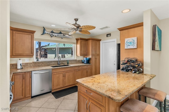 kitchen featuring visible vents, a kitchen breakfast bar, a peninsula, stainless steel dishwasher, and a sink