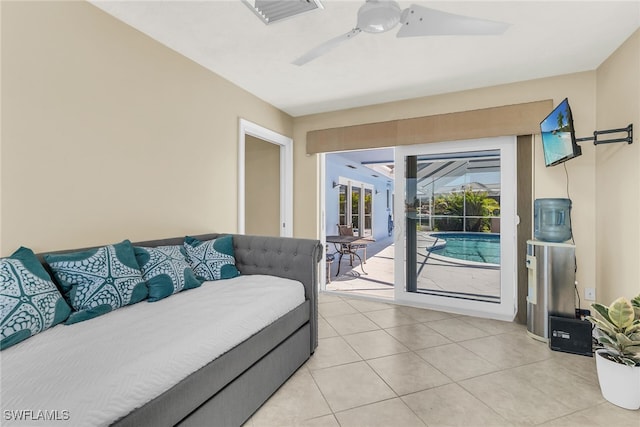 bedroom featuring access to exterior, light tile patterned floors, visible vents, and ceiling fan