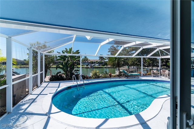 outdoor pool with a water view, a lanai, and a patio area