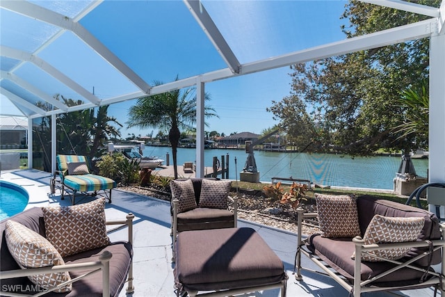 view of patio featuring glass enclosure, an outdoor pool, and a water view