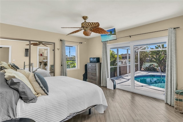 bedroom featuring a ceiling fan, access to outside, and wood finished floors