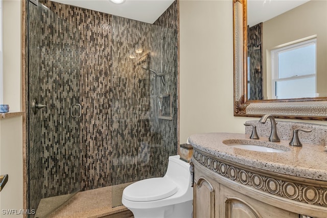 bathroom featuring a shower stall, toilet, and vanity