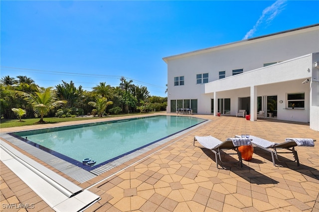 outdoor pool with a patio area
