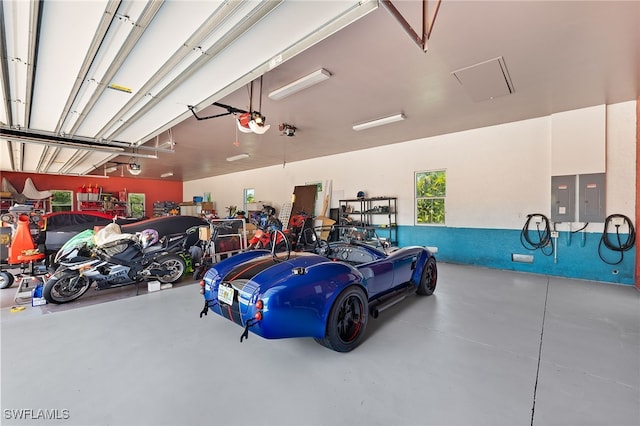 garage featuring electric panel and a garage door opener