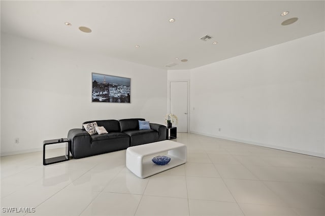 living area with tile patterned flooring, visible vents, recessed lighting, and baseboards