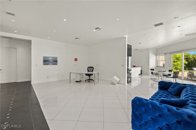 living area featuring light tile patterned floors, visible vents, and recessed lighting