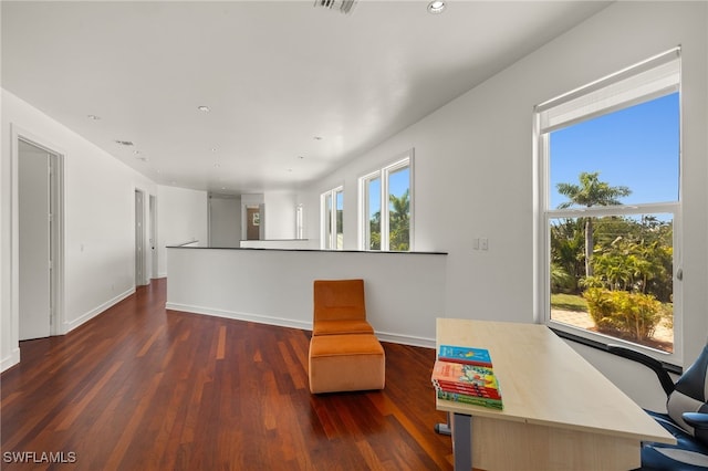 living area with recessed lighting, baseboards, and wood finished floors