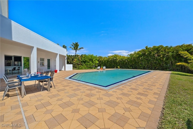 pool featuring outdoor dining space and a patio