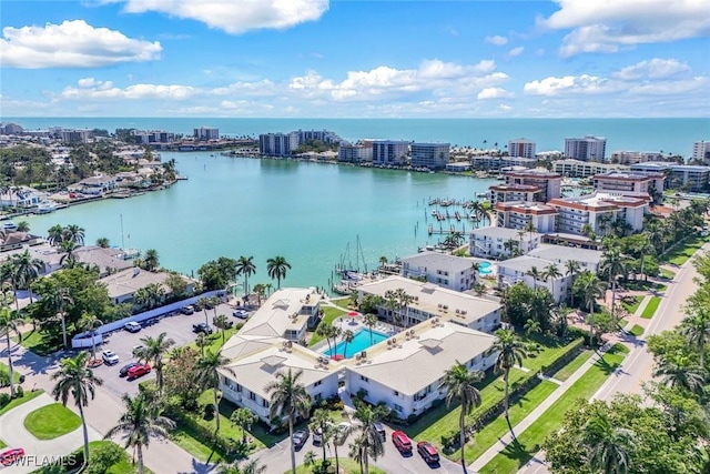 birds eye view of property with a water view and a city view