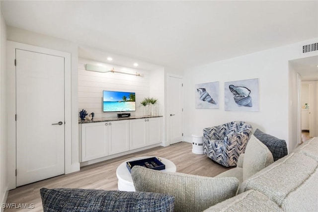 living room featuring visible vents and light wood-style floors