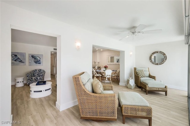 interior space with baseboards, ceiling fan, and wood finished floors